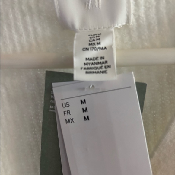 H&M cream sweater w two metal buttons and the top button has a jeweled bow. - Picture 3 of 3